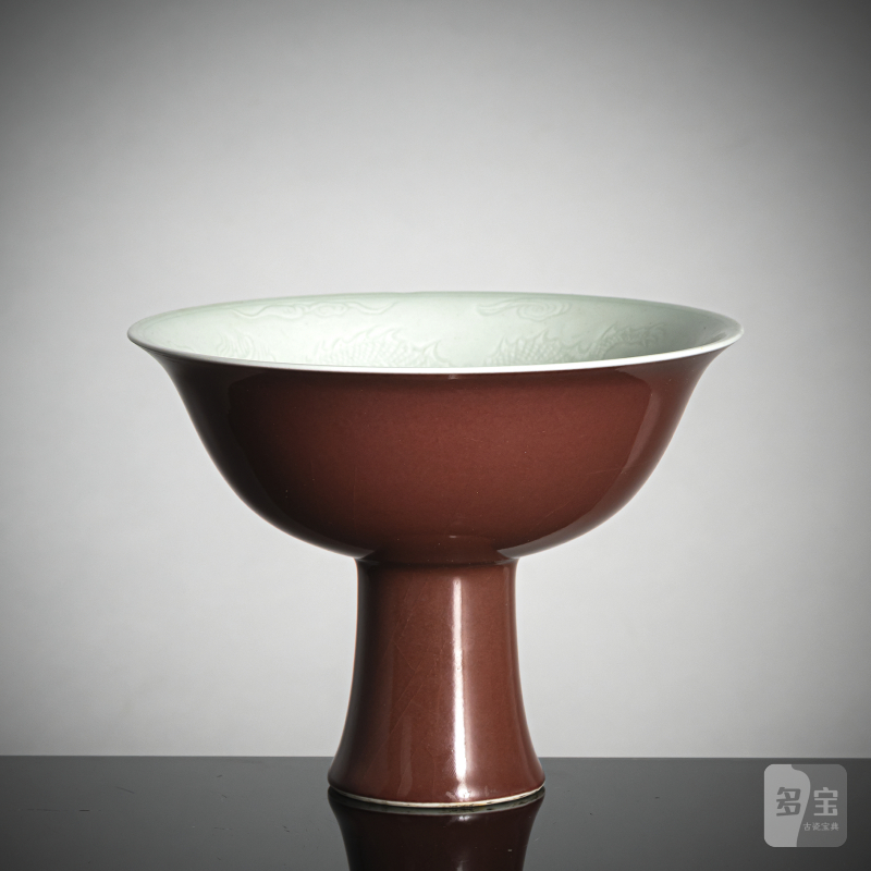 A copper-red glazed porcelain 'stemcup' with anhua decoration of dragons inside